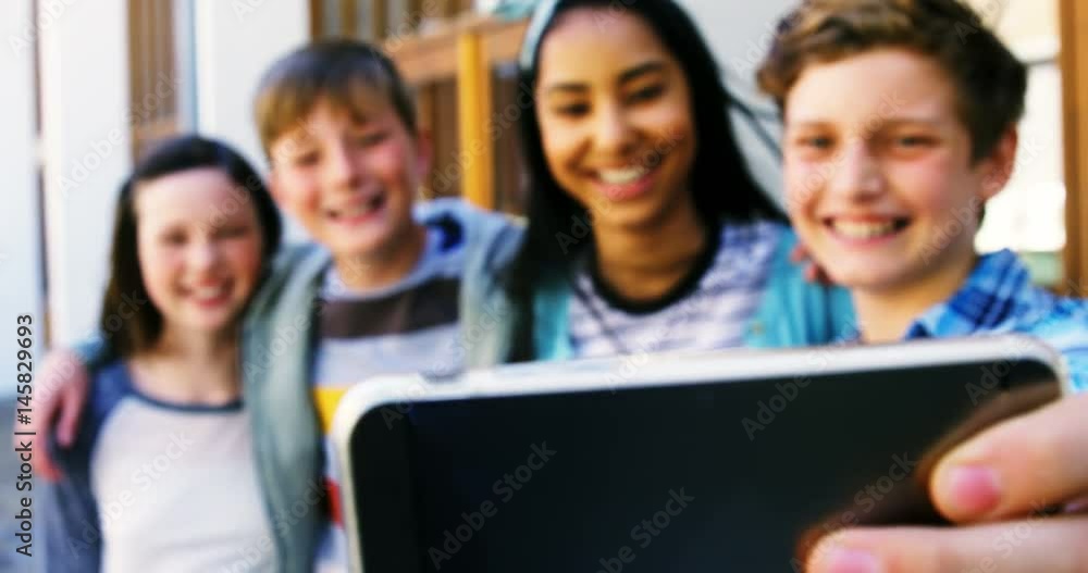 Smiling schoolkids taking selfie with mobile phone Smiling schoolkids taking selfie with mobile phone