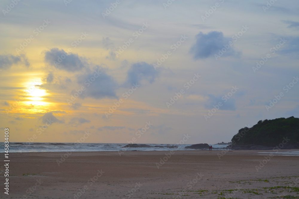 Sunset on the tropical sandy beach. Romantic time. Indian ocean. Sri Lanka.