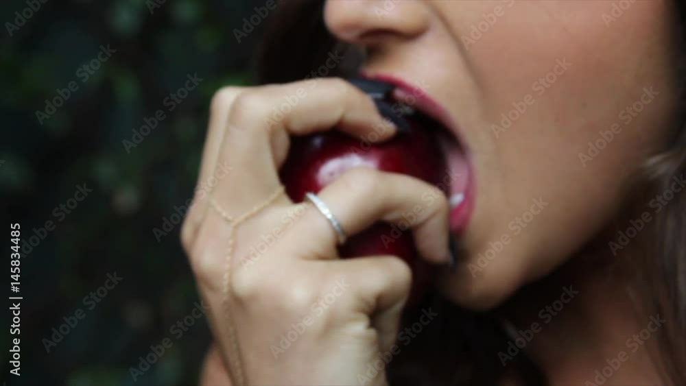 Eve lustfully bites into the forbidden fruit Eve lustfully bites into the forbidden fruit