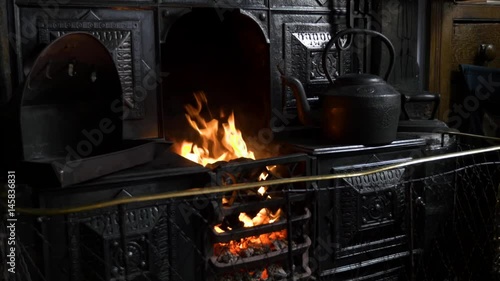 Cast iron traditional coal fired kitchen stove with flickering flames