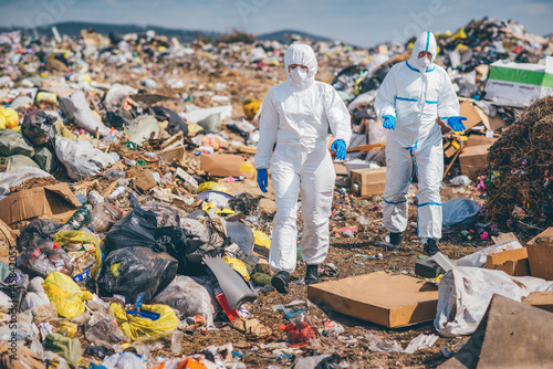 Recycling workers researching on the landfill