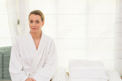 woman relaxing wearing bathrobe white background