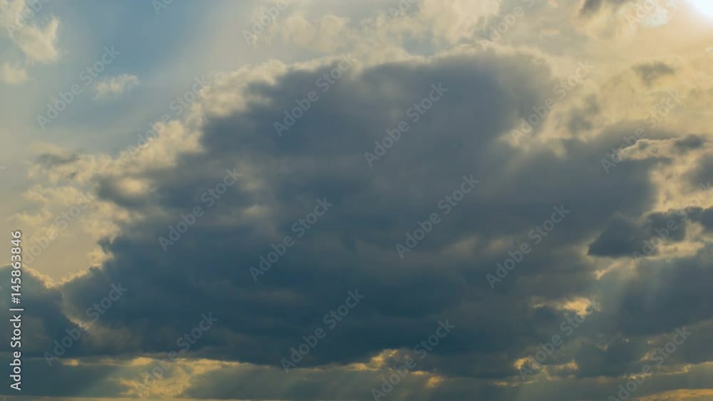 White clouds flying on blue sky with sun rays. Sun beams. Time lapse. White clouds flying on blue sky with sun rays. Sun beams. Time lapse.