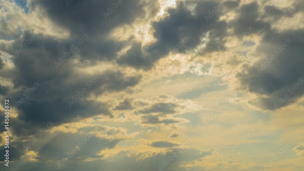 White clouds flying on blue sky with sun rays. Sun beams. Time lapse. White clouds flying on blue sky with sun rays. Sun beams. Time lapse.
