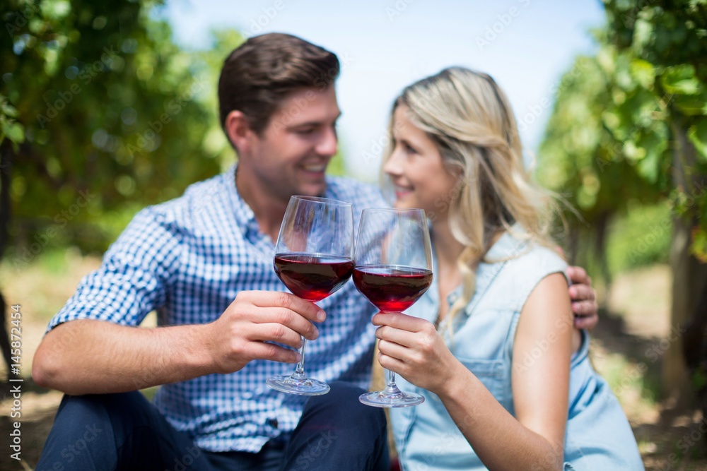 Couple with wineglasses embracing at vineyard Couple with wineglasses embracing at vineyard