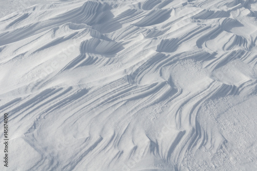 Snow like waves frozen from the winter winds.