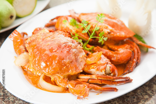 Fried red crab soup with herbs on white dish