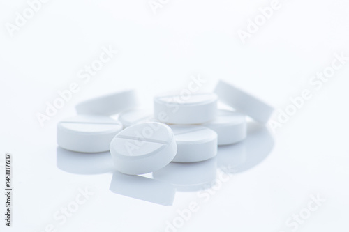 White pills on White background