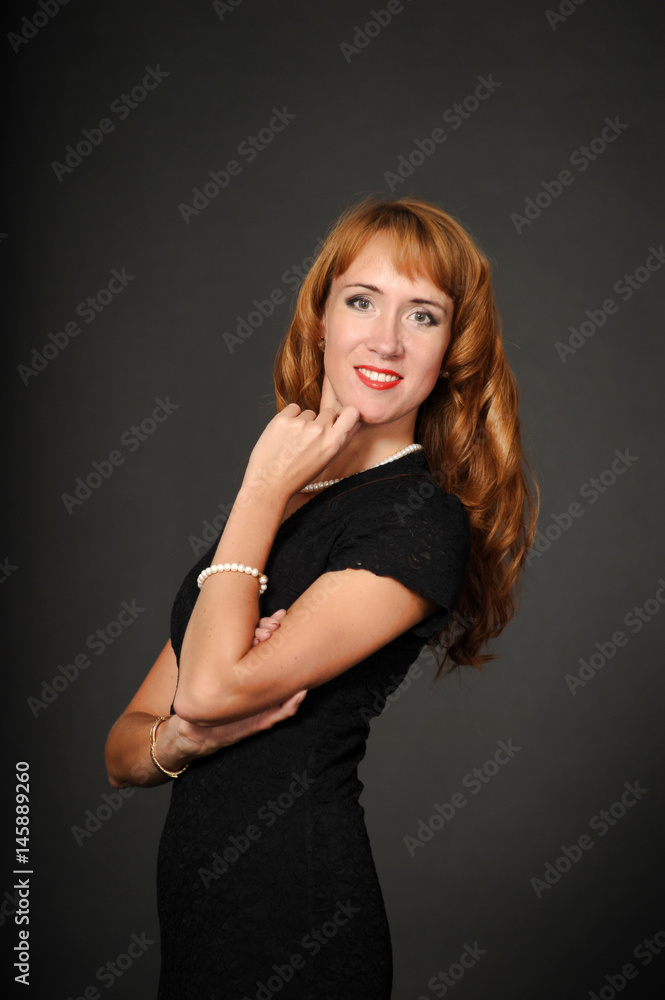 Portrait of red-haired girl in a black dress Portrait of red-haired girl in a black dress