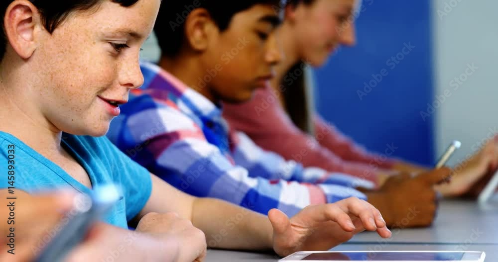 Students using digital tablet and mobile phone in classroom Students using digital tablet and mobile phone in classroom