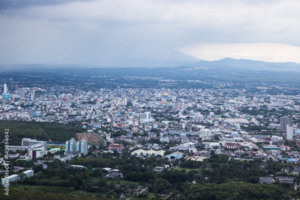 A view of the city from a window from a high point during a rain and Rain clouds at Thailand