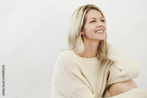 Lovely lady looking away in studio, smiling © sanneberg