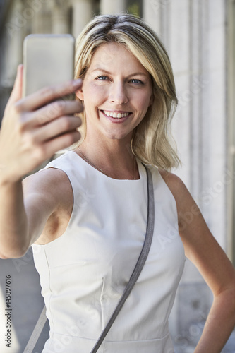 Blond and beautiful woman taking selfie