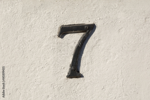 House number 7 sign on wall