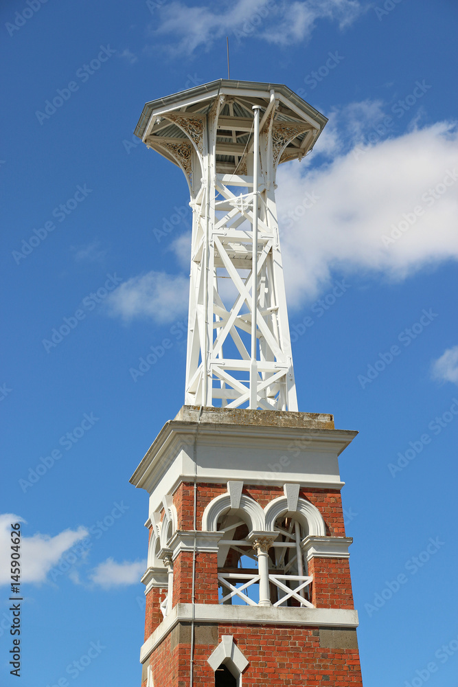 red brick fire belltower in blue sky