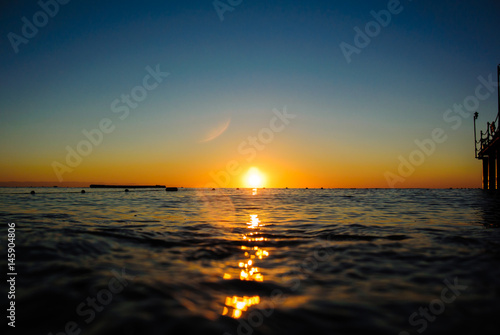 Colourful sea sunrise in soft waves  