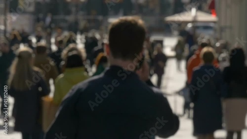 Wallpaper Mural Blurred unrecognizable people walk along sunny spring street slow motion video Torontodigital.ca