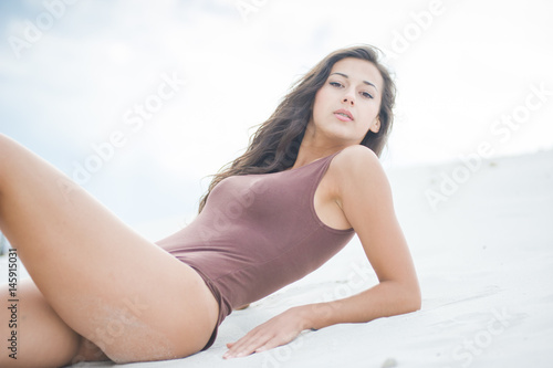girl in body and military boots posing on Sand Dune