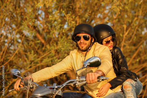 Beautiful young couple with a classic motorcycle © czamfir