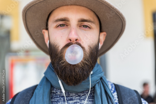 Stylish man chewing a gum