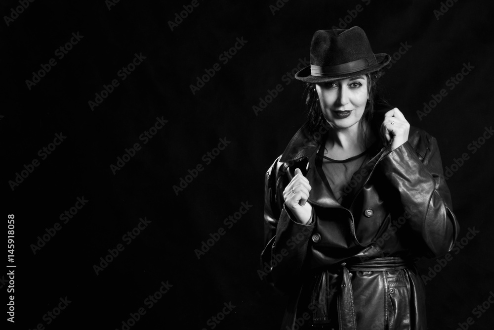 Elegant fashionable woman wearing black coat and hat