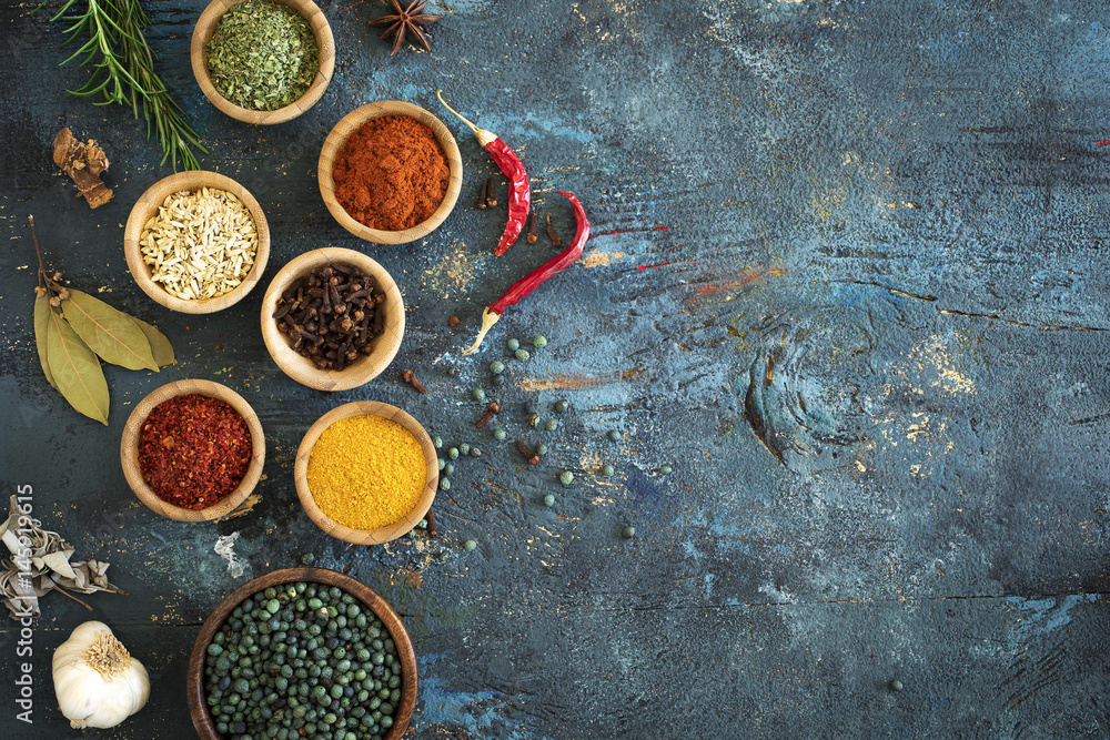 Spices and herbs on wooden background