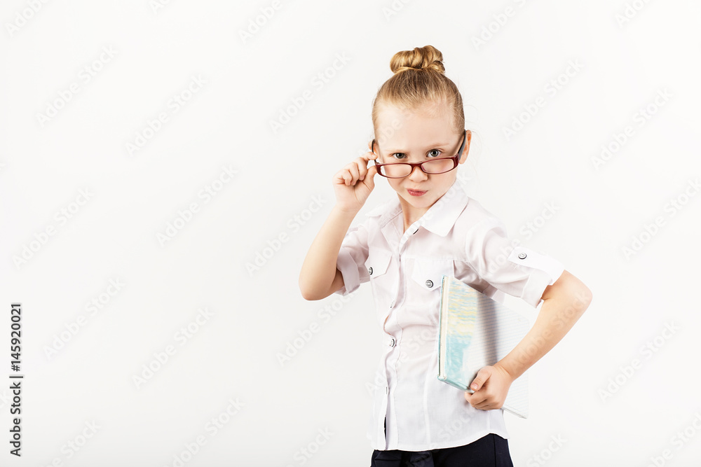 Funny smiling little girl imitates a strict teacher against white background. Funny smiling little girl imitates a strict teacher against white background.