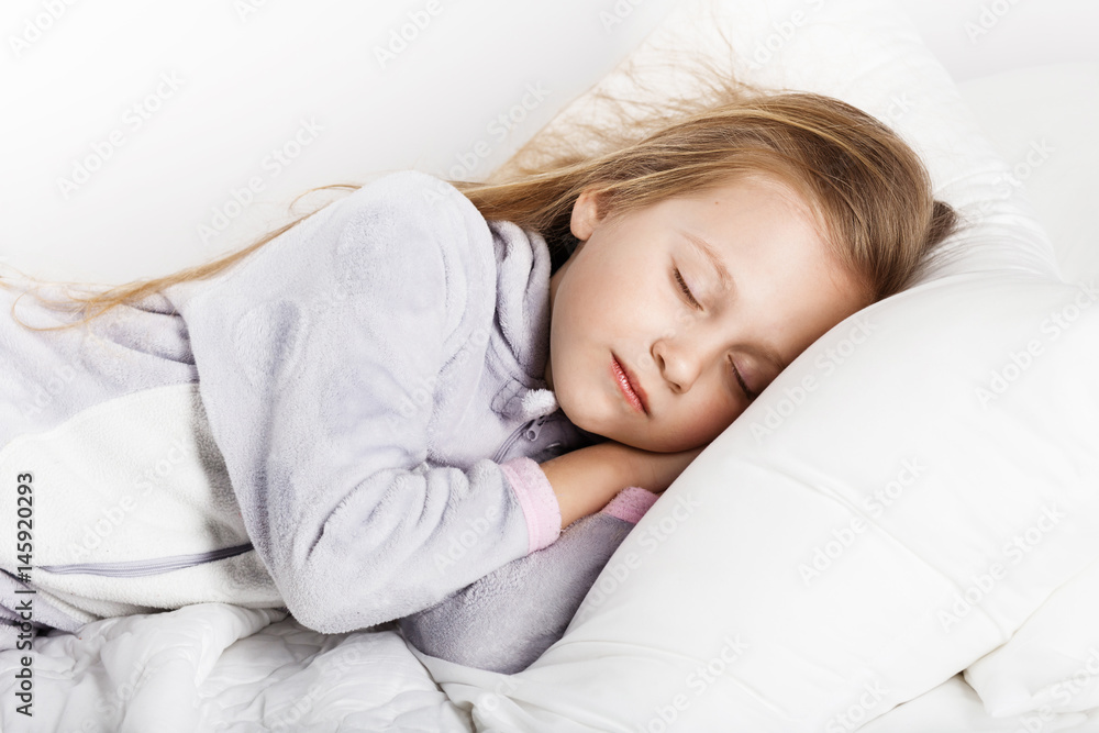 Adorable little girl sleeping in the bed
