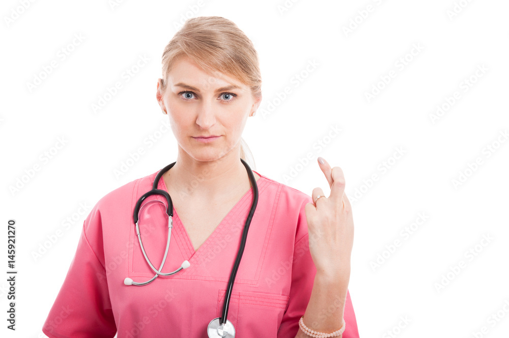 Attractive medical female nurse making fingers crossed gesture Attractive medical female nurse making fingers crossed gesture