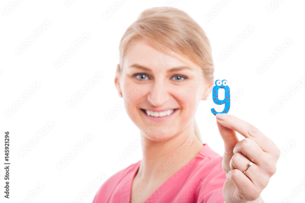 Selective focus close-up of pediatrician female showing number nine Selective focus close-up of pediatrician female showing number nine