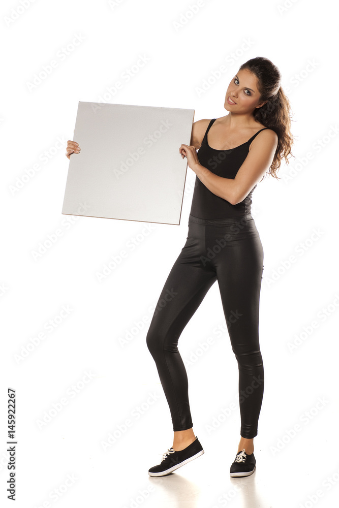 young beautiful brunette holding a blank board for advertisement young beautiful brunette holding a blank board for advertisement