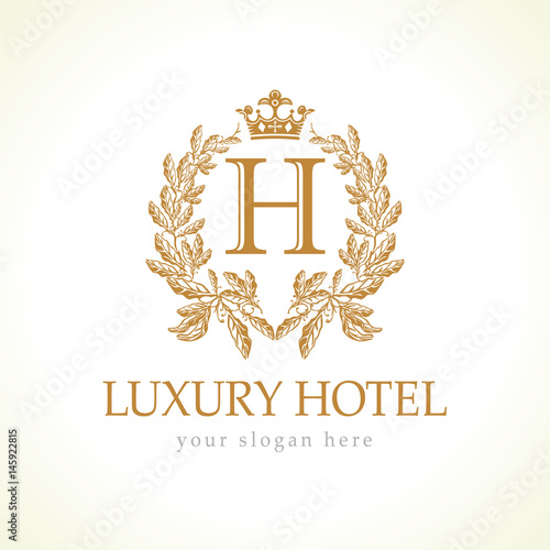 H company logo. Luxurious hotel. Coat of arms, gold colored royalty symbol. Elegant decorative branch of grapes and crown.