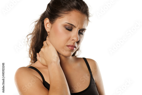 young beautiful brunette massaging her neck