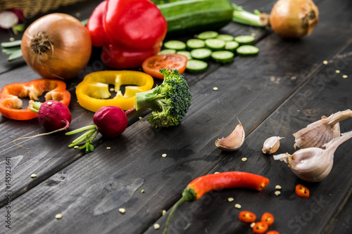 Close-up view of fresh seasonal vegetables on rustic wooden background