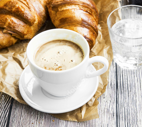 Coffee cup with croissant.Breakfast meal with fresh coffee and french pastry