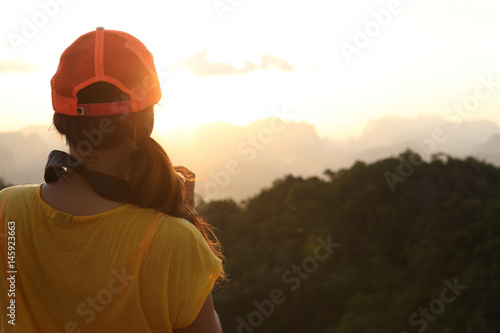 women take sunset photo