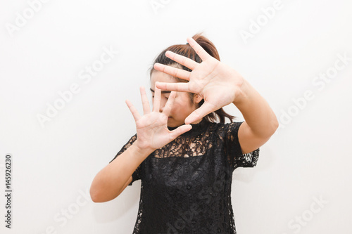 The woman put her hands up in defense afraid of something