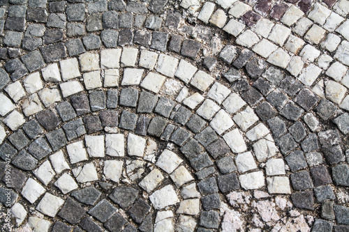 Old town street paving, circle pattern tiles. Vintage rocks