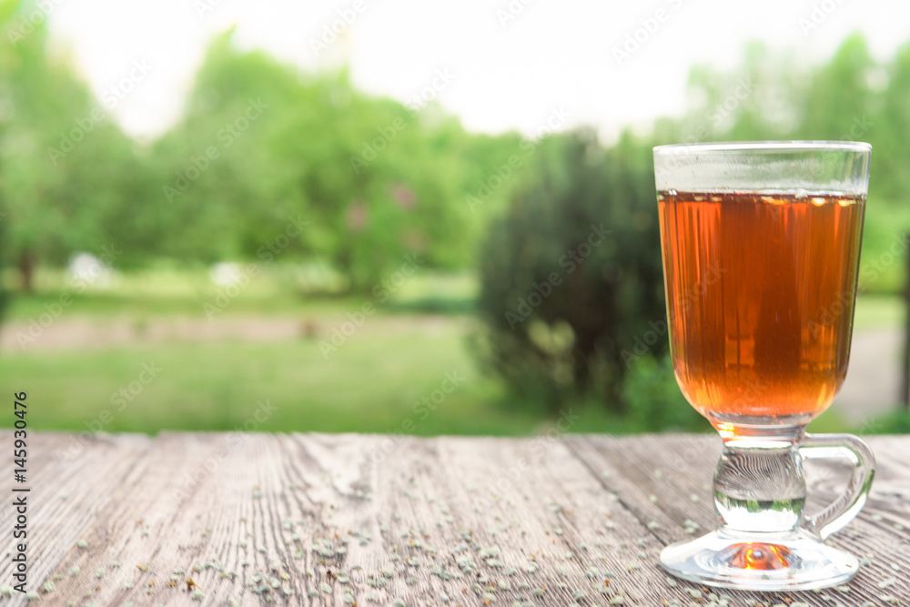 Glass of tea on table with herbs Glass of tea on table with herbs