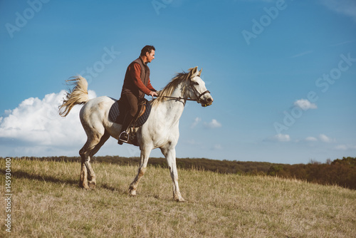 Man on white horse