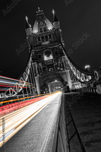 Fototapeta Naklejka Na Ścianę i Meble -  Tower Bridge in London in black and white, UK at night with blur colored car lights.
