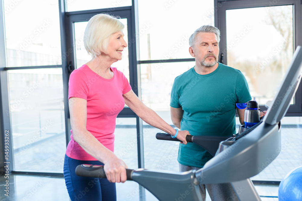 old sport couple training on treadmill in fitness class for senior people old sport couple training on treadmill in fitness class for senior people