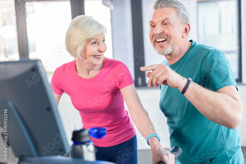 old sport couple training on treadmill in fitness class for senior people
