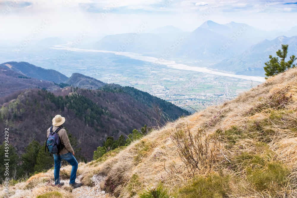 Hiker looking from Monte Chiampon to Friuli-Venezia Giulia