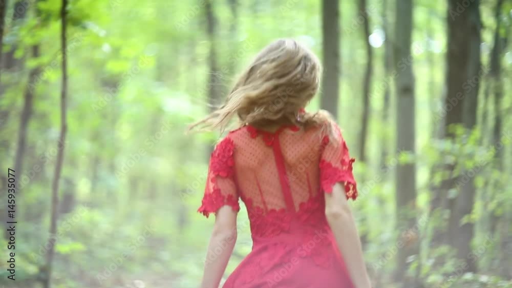 Beautiful Woman Walking Through Green Forest Beautiful Woman Walking Through Green Forest