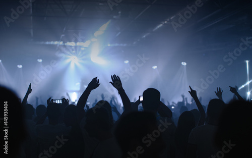 Man taking picture of a concert with smartphone