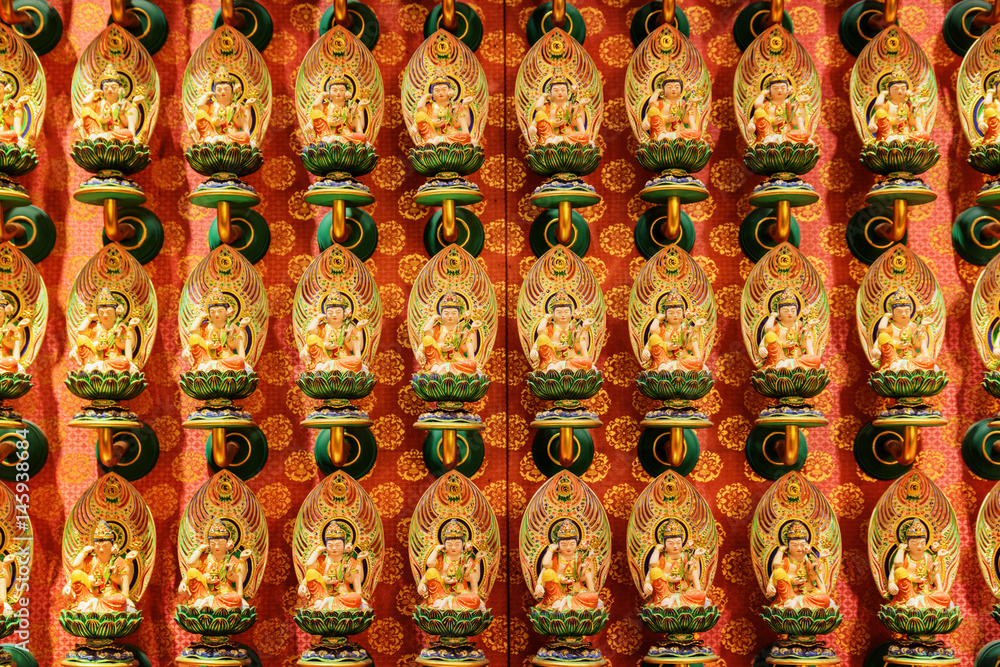 Wall with small colorful Buddha statues, Singapore