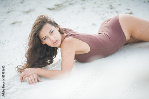 Fitness beautiful slim girl with brown hair posing