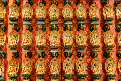 Wall with small colorful Buddha statues, Singapore