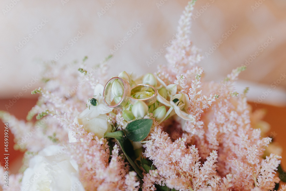 Closeup shot of wedding rings on a floral bouquet Closeup shot of wedding rings on a floral bouquet